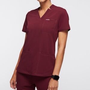 Jaanuu Helia Notched V-Neck 3-Pocket Scrub Top in Wine